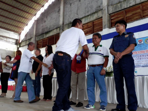 Department of Social Welfare and Development (DSWD) Field Office X Regional Director Nestor Ramos (2nd from right) and other officials congratulate drug surrenderers from Sugbongcogon, Misamis Oriental who finished the 12-day Community-based Rehabilitation Program organized by the DSWD and other agency partners.