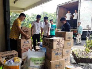 DSWD personnel prepare to load the donations of UP students for families affected by the Marawi crisis