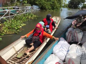 Department of Social Welfare and Development (DSWD) Field Office XII staff ride a boat just to reach and deliver relief assistance to residents affected by flooding in Northern and Southern Kabuntalan, Maguindanao.