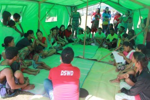 A DSWD social worker facilitates the psycho-social processing activity with the evacuees. 