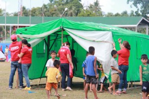 DSWD-Field Office CARAGA  staff set up tents for the women and child-friendly spaces.