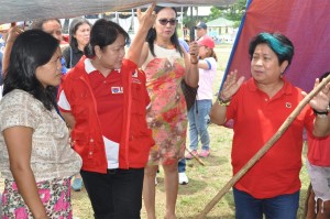 DSWD Sec. Soliman engages an evacuee of the Surigao del Sur incident during her recent visit to the evacuation center where she met with local officials and community leaders. Also in photo is DSWD-CARAGA DIrector Minda Brigoli (center​ in red vest).