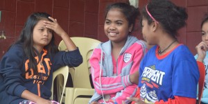 Lea (center) beams as she engages in light banter with fellow Pantawid Pamilya beneficiaries.