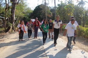 Community residents of Barangay Alegria and key officials and staff of DSWD, and local officials go on a ceremonial walk on the access road constructed through Kalahi-CIDSS. 