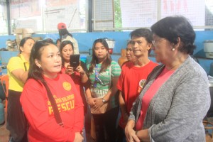 DSWD Sec. Taguiwalo interacts with volunteers helping manage the Geronimo Covered Court evacuation center for Habagat evacuees in Brgy. Silangan, Quezon City