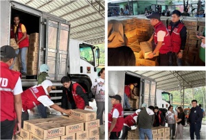 Personnel from the DSWD Field Office XII haul boxes of family food packs for distribution to flood victims in Kabacan, Cotabato Province.