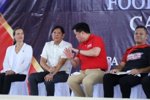 President Ferdinand R. Marcos Jr listens as Department of Social Welfare and Development (DSWD) Secretary Rex Gatchalian  gestures and stresses a point during the launching of Walang Gutom 2027: Food Stamp Program on Sept. 29, 2023 in Caraga Region. (File Photo)