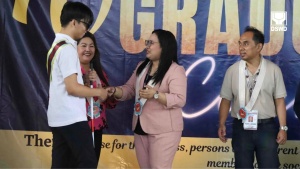 Jude Anthony Oriondo, a blind person, receives his certificate of training completion from Department of Social Welfare and Development (DSWD) Assistant Secretary Elaine F. Fallarcuna during the 70th commencement exercise on Friday (May 10) conducted by the National Vocational Rehabilitation Center (NVRC) for persons with disabilities who finished social and vocational training at the center.